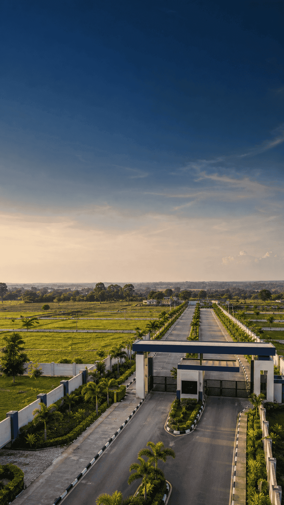 Planned estate land with road access and green surroundings